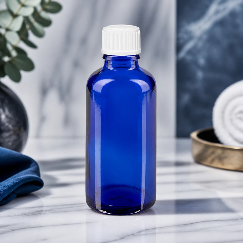 Frasco conta-gotas STD de 50 ml em ApoGlas, azul cobalto, com tampa branca e acabamento em mármore