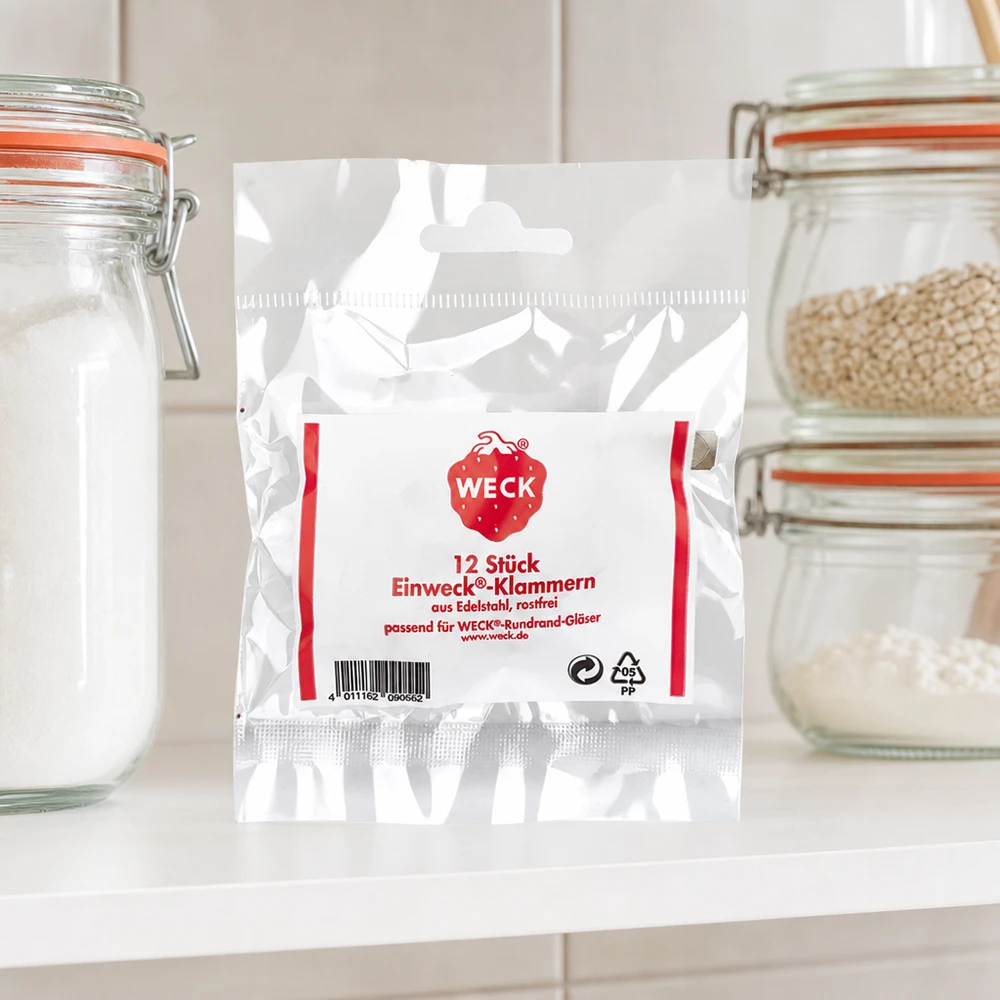 Embalagem de produtos com grampos WECK na cozinha entre frascos de armazenamento com farinha de cereais em ambiente de cozinha de bancada branca